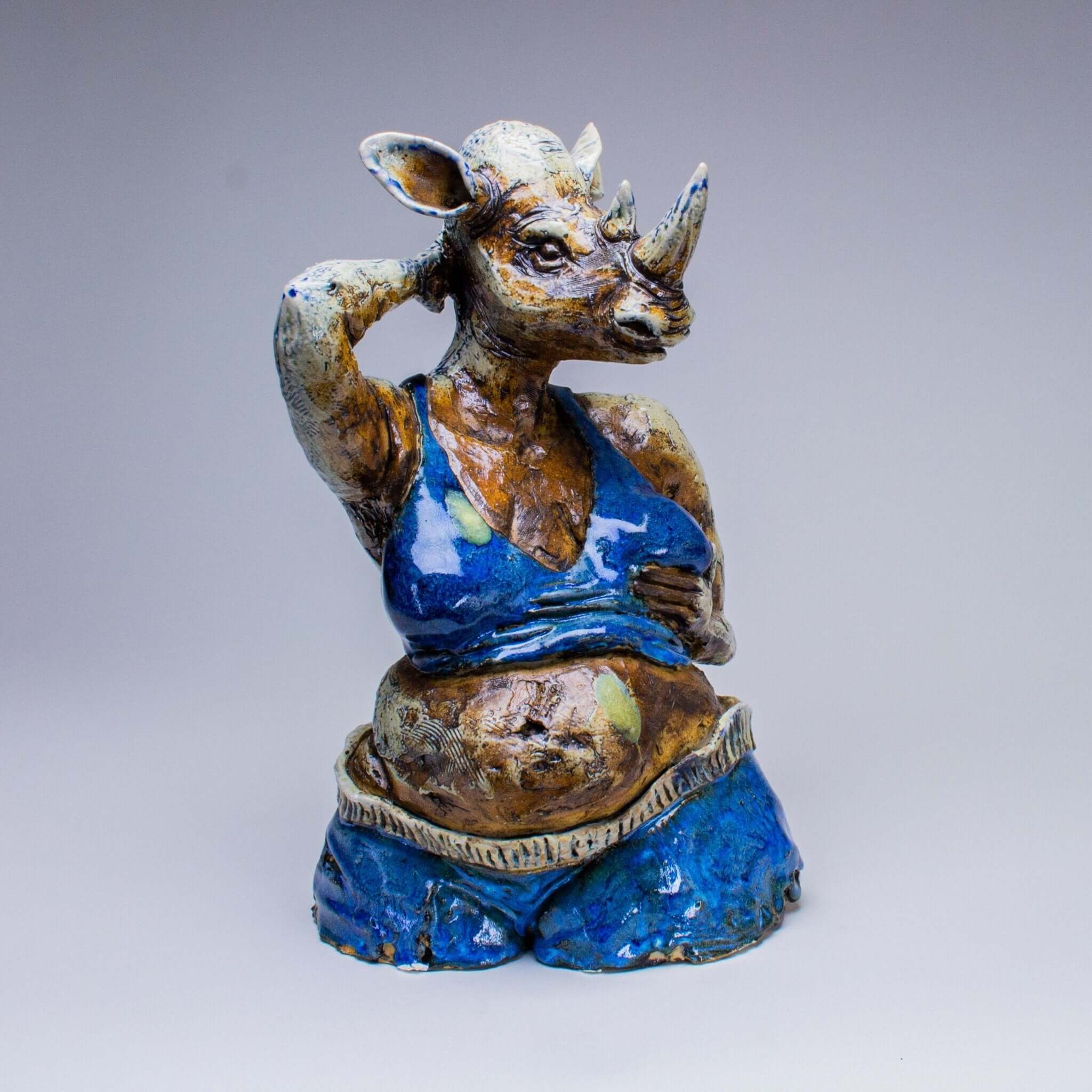 Unique seated figure sculpture with an animal head